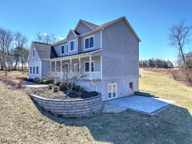 Welcome to this stunning Colonial in Branchburg's sought-after Crestview neighborhood. Built in 2020 and situated on over an acre of beautifully maintained property, this 5-bedroom, 3-full-bath home offers the perfect blend of style, comfort, and functionality. A charming covered front porch welcomes you inside, where a flexible living room can easily serve as a home office, and a formal dining room leads to the heart of the home. The gourmet kitchen features granite countertops, a center island, and pendant lighting, opening to a spacious family room filled with natural light from expansive windows and sliding doors to the backyard. A full bathroom on the main level adds convenience for guests.Upstairs, the luxurious primary suite includes a sitting room with vaulted ceilings, a sunny reading nook, a walk-in closet, and a spa-like bath with a jetted tub, separate shower, and dual-sink vanity. Four additional generously sized bedrooms, a full bathroom, and a second-floor laundry room complete the upper level.Additional features include a walk-up attic, a full walk-out basement ready for future finishing, and a Tesla solar system with solar panels and two Powerwalls for energy efficiency, lower utility costs, and backup power. Conveniently located near major commuter routes, shopping, and everyday amenities, and within a highly rated school district, this exceptional home is ready to impress.
