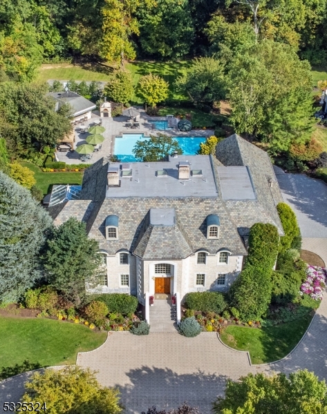 Country club living in your own backyard! Exquisite custom all brick estate w/Vermont slate roof, located in double cul-de-sac upscale neighborhood. Privately set on over 3 acres. This extraordinary estate offers luxurious living & timeless beauty inside & out.The estate offers 4 levels of living, a massive outdoor entertaining area featuring a cabana pool house w/kitchen & full amenities, 25x50 heated pool & separate spa, granite patio, sports court, & paver circular driveway.No expense spared. Adorned w/Swarovski crystal chandeliers, granite, marble & wood flooring, dentil moldings. 5 bedrooms, 7.3 baths, two-story grand foyer, formal living rm w/fireplace, formal dining rm w/ 2 French doors to stunning conservatory, a true chef's kitchen w/top-of-the-line appliances, w/4 ovens, 2 d/w, 2 refrigerators, great rm w/3-sided fireplace, full bar, built-in entertainment center, & 2 French doors to patio. Lavishly appointed primary suite w/fireplace, 2 French doors to veranda overlooking lush grounds, 2 custom walk-in closets, primary bath features 2 private powder rms, jetted tub & over-sized shower. Two add'l en-suites, two add'l bedrooms & main bath. Third level is complete w/maid's quarters, & storage. Full finished walk-out basement w/full bar, rec room w/fireplace, family room, gym, full bath & wine cellar. Natural gas generator, 13 zone baseboard heating, 9 zone central air, 12 zone irrigation, low level exterior lighting, heated driveway bordering garages.Too much to list!