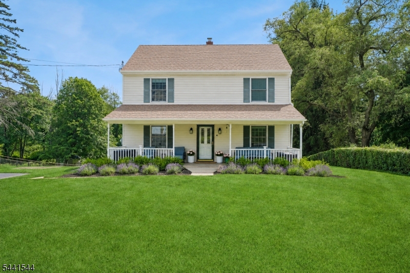 Welcome to this charming Colonial tucked on a quiet street in one of Randolph's most sought-after neighborhoods. Set on over a half-acre lot with mature trees, this beautifully maintained home offers the perfect blend of location, space, & privacy, plus a brand-new central A/C unit. The inviting front porch leads into a spacious, sun-filled layout with hardwood floors throughout, a large living room, open dining area that can also serve as a sitting room, & a beautiful eat-in kitchen featuring granite counters & stainless steel appliances. With 3 bedrooms & 2 full updated baths, the home offers a highly functional layout, including 1 bedroom & 1 bath on the 1st floor, ideal for guests, a home office, or flexible living. Upstairs, the massive primary suite impresses with a dramatic vaulted ceiling, large walk-in closet, & updated en suite bath. A 2nd large bedroom, also with private bath access, plus a convenient upstairs laundry room with ample storage complete the 2nd level. The finished walkout basement adds valuable living space with a large rec room, storage, & flexible space for work or play. Outside, enjoy a huge private backyard & patio with direct kitchen & basement access, ideal for outdoor dining & entertaining, & an oversized lot offering potential for future expansion. Perfectly located just steps from Brundage Park with easy access to Randolph's beloved trail system & highly regarded schools - this home is a rare opportunity in a truly special location!