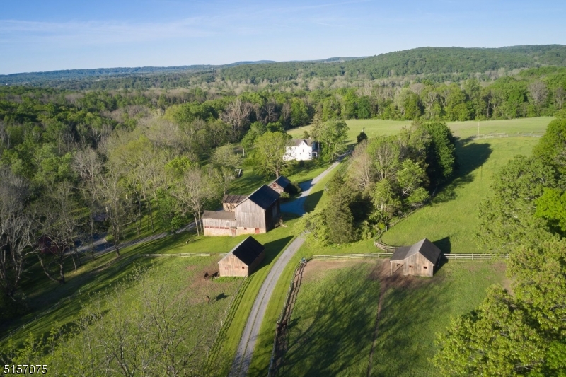 Rarely does the opportunity come along to own some of the finest land in the kingdom! Plum Broke Farm is just that, and so much more. Located minutes outside of charming Stockton on 90+ stunning acres of preserved land reminiscent of the English countryside, this country estate has long been admired by all those fortunate to visit it. Two impressive driveways meander through open pastures & wooded trails almost 3/4 mile long! A stunning setting, with approximately 30+ acres of pasture, 30+ open acres & 37 wooded acres, the land also has a spring-fed pond & sparkling stream, dotted with boxwood & flower gardens, stone walls & majestic trees. Perfect setting for the equestrian, sheep farmer or livestock. The fields have some of the finest alfalfa, clover & timothy orchard grass. The historic barn features a cobblestone courtyard leading to a 7-stall horse stable, tack room, hot/cold wash stall & hay storage. There are 4 large run-in sheds & an outdoor riding ring. The carriage house currently is used as an office but has served the property as a caretaker?s & guest quarters. A quaint 3 BR Victorian house has scenic pastoral views & a separate, private entrance. An opportunity awaits to build the house of your dreams with one residential dwelling, as per the Deed of Easement requirements. Additionally, there is a separate 2 BR 1700s stone house on separate 1.45-acre parcel, with private driveway and 2-bay barn with storage above. Priced separately.