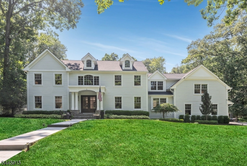 Making an unforgettable first impression on over 1.7 private acres within Allendale's coveted San Jacinto Estates, this exceptional custom home offers a lifestyle rarely found in Bergen County where peaceful, park-like surroundings, complete privacy, and a welcoming community come together in one extraordinary setting. Just moments from top-rated schools, Crestwood Lake, charming downtown shops and restaurants, and convenient NYC transportation, the location is as remarkable as the home itself. Thoughtfully expanded and beautifully renovated, the sun-filled interior showcases soaring ceilings, expansive living spaces, and a seamless flow throughout. The spectacular chef's kitchen with dual islands opens to a breathtaking great room with a fireplace and dramatic 18-foot sliding doors, while elegant formal living and dining rooms, a private office, and thoughtfully designed supporting spaces provide exceptional everyday functionality. Upstairs, five spacious bedrooms include a luxurious primary suite with a custom walk-in closet and a spa-inspired bath. The finished lower level offers a recreation room, game room, fitness room, and direct outdoor access. Outside, a sprawling patio overlooks lush, park-like grounds complete with a raised koi pond, hot tub, and mature privacy plantings, creating an extraordinary setting for both everyday living and unforgettable entertaining.
