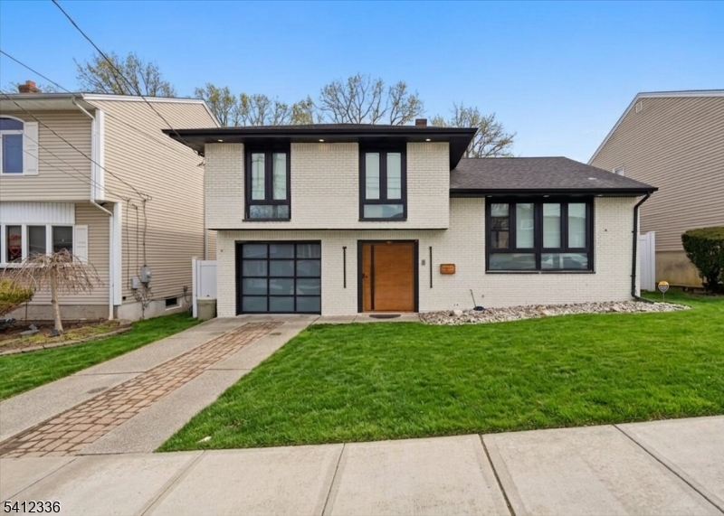 Floor-to-ceiling windows, a high-tech revolving front door, and a full-length deck overlooking Schmidts Wood set the tone for this beautifully renovated single-family home in Secaucus' desirable North End.offering 4 bedrooms and 4 full bathrooms, this move-in ready residence features an open-concept living and dining area perfect for everyday living and entertaining. The eat-in kitchen is equipped with granite countertops, a waterfall island, and brand-new appliances. Brand-new hardwood floors run throughout, complemented by freshly updated walls and ceilings for a modern, clean aesthetic.The spacious primary bedroom includes a private ensuite bathroom. A fully finished basement provides additional living space complete with a bedroom or a home office. Renovated throughout with quality finishes and thoughtful design, this home offers space, style, and versatility in a prime location right next to Schmidts Wood Park.