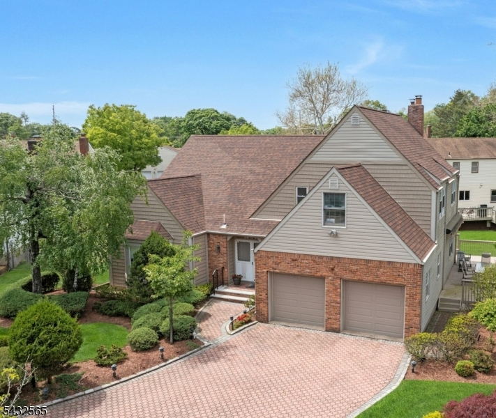 Great Price Reduction! Welcome to a stunning updated expanded & timeless col showcasing 5BR/3/5 Baths all within a top-rated blue ribbon school district near houses of worship & NY transportation. Step into a grand dbl entry foyer w/soaring ceiling & adorned with an antique chandelier. Entertain in the expansive LR w/bow windows &HW floors. Opens to DR that is highlighted by a showstopping chandelier &travertine marble tile flooring.  Updated well-appointed chefs kit w/granite counters, premium monogram SS appliances, 6 burner stove w/oven, wall-oven/warming draw  wave w/Classy cherrywood cabinets as well as under cabinet lighting. Breakfast rm w/door out to a huge 2 tier deck w/retractable awning & adjoining spacious Fam/Rm w/FPL. Laundry &PR complete this level. Imagine 5 total BRs on the second level. Lg Primary BR w/2 WIC & private en-suite bath. Four add'l brms & Hall bath w/dbl sinks &jacz tub. Spacious fully fin-bsmt w/rec room, wet-bar& ample storage &closets. Attention to detail &beautifully updated &expanded. A list is provided which includes paver drive& walkway, 4 Z heat&AC, security system, 5 Zsprinklers, crown-molding, recess lighting, built-in speakers. This pristine home is the perfect blend of Elegance &functionality. Enjoy a serene private picturesque yard & notice a babbling brook in the rear. You can have it all, an expanded updated home in a Great Neighborhood, on a Cul-de-Sac and Top Location!