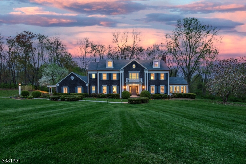 Behind a gated entry on a private cul-de-sac, 1 White Deer Lane sits on 3.1 acres in Harding Township, bordering Chatham. A 2025-2026 studs-up rebuild with fully custom finishes, the home offers five en-suite bedrooms and 6 full, 2 half baths across three floors plus a partially finished basement. The first floor features a designer kitchen with custom island seating five, shiplap ceiling, exposed beams.  The family open to the kitchen, offers a soapstone fireplace surround & hearth, custom wet bar &French doors to the bluestone terrace. Directly off of the kitchen, the dining room serves everyday meals and larger gatherings with equal ease. Across the entry hall, the living room holds the home's second fireplace & flows into a sunroom with expansion possibilities, tray ceiling & windows on 3 sides. The mud room, laundry, full pool bath and three-car garage complete this level. Upstairs, the primary suite features a spa-like bath and custom walk-in closet with center island. Three additional en-suite bedrooms and a stackable washer/dryer complete the second floor. The third floor adds another en-suite bedroom, ideal as an office or guest suite, cedar closet and walk-in attic. The partially finished basement includes a movie room, home gym, and storage room. Outside, a heated, fenced pool is surrounded by a paver patio. Minutes from Chatham Mall, Madison, Morristown, and Summit nearby. Commutable to NYC via Routes 287, 78, NJ Transit, and BoxCar from Madison and Chatham.