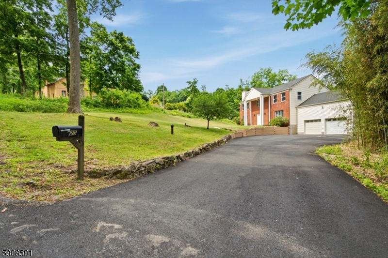 Set on a private 1-acre corner lot, this beautifully updated Colonial offers approximately 2,588 sq ft of living space with multi-generational living potential and a separate entrance. Recent upgrades include a brand-new gas furnace, central air conditioning, hot water heater, fresh paint, modern lighting, new hardwood flooring, and all-new appliances. The main level features a spacious living room with wood-burning fireplace, formal dining room, powder room, and family room with sliding glass doors to the deck. The eat-in kitchen is ideal for everyday living and entertaining, showcasing granite countertops, new cabinetry, center island with sink, double wall oven, gas cooktop, bay window, and three pantries. Upstairs offers four generously sized bedrooms, two full baths, and laundry. The primary suite includes a private bath with double vanity and walk-in closet with window. The separate living space provides flexibility with a large bedroom, living room, family room, full bath, and kitchen. Additional highlights include abundant natural light, an oversized two-car garage, and a driveway accommodating 4"5 vehicles. Conveniently located in the Budd Lake area of Mount Olive Township with easy access to major highways, shopping, dining, and recreational amenities. This move-in-ready home delivers space, comfort, and versatility in a desirable location.