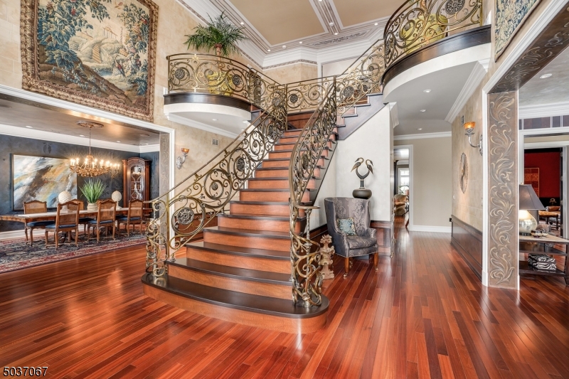 Welcome to this spectacular 6 BR, 7.2 bath custom built Georgian Colonial. The tone is set upon first entering the exquisite two-story foyer showcasing the trompe l'oeil ceiling, mahogany stairs with a hand-made bronze railing, high ceilings, Brazilian cherry floors,  walnut burl wainscoting, crystal door knobs w/white bronze hardware, custom murals & so very much more. Exquisitely renovated eat-in kitchen, striking MBR suite w/the most incredible bath (Breccia Antiqua stone shower), gorgeous silver tub by Water Works, plus 6 more stunning baths, 3 walls of soaring windows in the conservatory w/an Onyx floor, custom mahogany doors w/book matched walnut burl panels, 3000 bottle wine cellar plus a tasting room, 10 seat home theatre, gym, billiard room, library, 3 fireplaces, Creston a/v system, copper gutters.