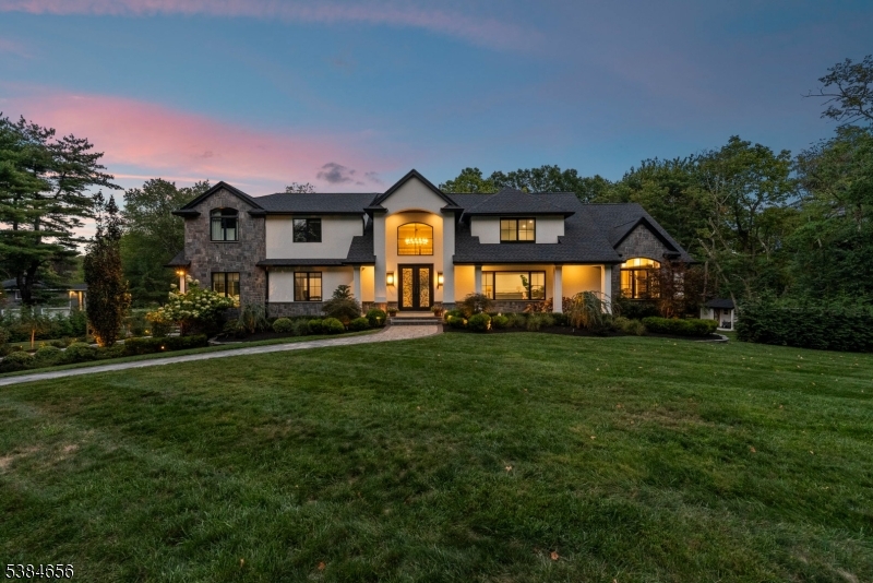Luxury living at its finest! Elegance begins at the curb, where a custom driveway with a Belgian Block entrance immediately sets the tone for sophistication. Oversized European metal doors are more than just an entryway they're a bold statement, welcoming you into a grand two-story foyer. The chef's kitchen boasts a massive quartz island, full-height quartz backsplash, and high-end stainless appliances, including a 48-inch Thermador gas range with pot filler. The oversized family room with fireplace offers sliders to a composite deck for seamless indoor-outdoor living. A private home office with custom built-ins, a living room with extensive woodworking and coffered ceilings, and a dining room with arched doorway and tray ceiling are all bathed in light from Andersen 400 Series windows. The first-floor primary suite features a spa-like ensuite bath, while upstairs you'll find six bedrooms, including another luxurious primary retreat. The lower level provides a full additional living space with a flex rooms,  two full baths, full kitchen, and family room ideal for guests or an au pair. With 7 bedrooms and 7 full baths, the home showcases custom millwork and thoughtful finishes throughout. Outdoors, nearly one acre of manicured grounds offers deck, patio, gardens and walkways for both relaxation and entertaining. Perfectly situated in a highly sought-after neighborhood with top-rated schools and unbeatable access to shopping, dining, and commuting routes.