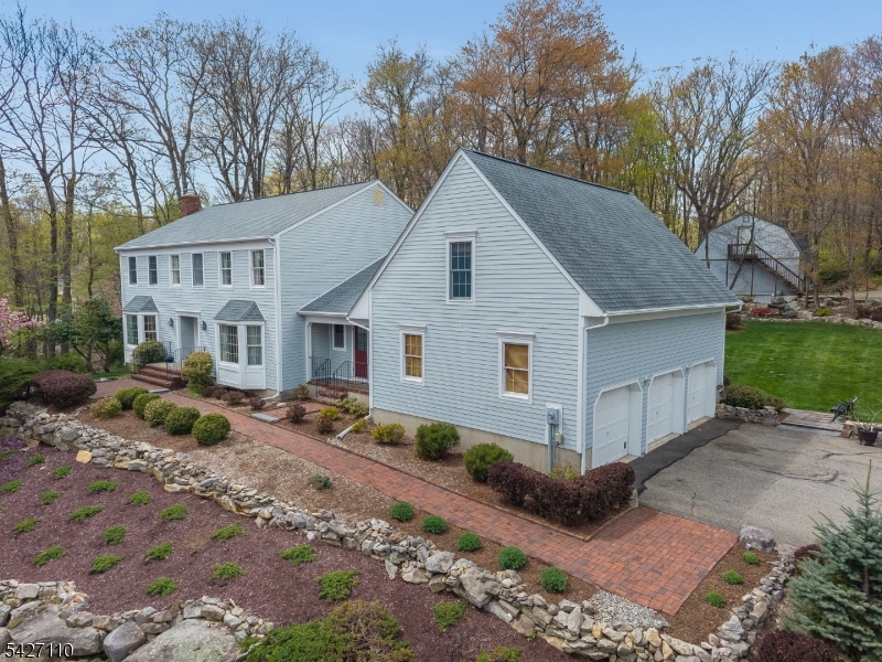 Immaculate, center hall colonial offered by the original owners, located in sought-after Tewksbury Township with a desirable Califon mailing address. This beautifully maintained 4-bedroom, 2.1-bath home offers exceptional space for both everyday living and entertaining inside and out. The main level features hardwood floors, fresh paint, and an oversized living room for added openness. Family room showcases a stunning custom fireplace with reclaimed brick, Heatilator, and built-in bookcases. The kitchen is enhanced with custom millwork, beadboard, a walnut center island, and antique stained glass cabinet accents. A convenient first-floor laundry completes the level. Upstairs, is the spacious primary suite and additional bedrooms, upstairs from the kitchen is a bonus room over the garage, offering flexible living space. Outdoor living is exceptional with a screened-in porch featuring a bluestone patio, and a custom wood-fired oven perfect for entertaining. Additional highlights include a partially finished basement with Bilco door access and higher ceilings (extra course of block), Andersen windows, Hardie Board/cedar siding, roof 2013. Car enthusiasts and hobbyists will appreciate the attached 3-car garage with laminated beam for added storage potential, along with a separate pole barn offering approximately 3+ car capacity and a full storage loft above. A rare opportunity combining craftsmanship, space, and versatility in one of Hunterdon County's most desirable locations.