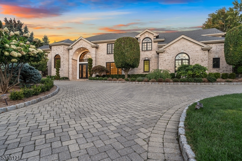 A stately brick Colonial located in the prestigious East Hill Estates. Built by acclaimed developer Joseph Di Staulo, this 6 bed, 8 bath residence offers over 6,300 SF of living space on nearly 1 acre of manicured grounds. The grand entry opens to a 2 story marble foyer, flowing into elegant formal rooms, a library and a sun filled great room with soaring ceilings and a wall of windows. A brand new gourmet kitchen with breakfast area makes entertaining seamless, while multiple fireplaces add warmth and character. The home has been freshly painted and all hardwood floors have been refinished. The 2nd level features a luxurious primary suite with spa like bath, along with 4 additional bedrooms. The finished lower level includes a recreation room, lounge, 2 baths, storage and separate entrance. Outside, the resort style backyard is a private oasis with an infinity edge saltwater pool, spa, waterfalls and expansive terraces, all set within Cresskill's highly sought-after Tammy Brook Hills.
