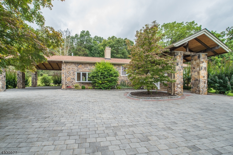 Beautiful, Sprawling, updated Mediterranean Ranch! Fabulous Floor Plan. Welcomed by a custom designed entranceway w/Stone Columns & tongue & groove ceiling?Walk into the Open DR/Kitchen, accentuated by the stone-faced WB fireplace. Bright Kitchen w/Granite Counters, oversized Island & marble floors. Step down to grand LR w/Custom wood beamed ceilings & gas fireplace. Gorgeous HW flooring & extensive stone/tile work throughout. 4 generous bdrms equipped with lots of closet space. Unique 1st floor Master suite showcases a glass stall shower, jetted tub, water closet & fireplace. 2nd bdrm & Main bath features marble, glass shower which completes the 1st level. Flexible Finished Room in bsmt with the 2 additional bdrms & half bath. Situated on over an acre of property w/easy access to hwys, shopping & schools.