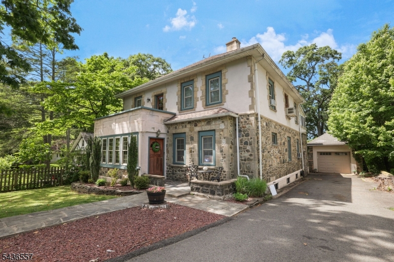From the moment you step into this charming 4-bedroom, 2.5-bathroom Colonial located in Erskine Lake Community, you're welcomed by warmth and timeless appeal.  An inviting sunroom with stone walls, oversized windows, and wood trim creates the perfect first impression. The sunroom flows into the spacious living room featuring custom moldings, a wood-burning fireplace, and an inviting atmosphere for entertaining or relaxing. French doors open to a versatile playroom ideal for recreation, hobbies, or home office. The updated eat-in kitchen boasts custom cabinetry, granite countertops, stainless steel appliances, and bar seating, while a large cased opening leads to the formal dining room, perfect for gatherings. Just off the kitchen, a mudroom with built-in storage and bench adds convenience. A few steps down, the sunlit den features a second fireplace and sliding glass doors leading to the rear deck. Upstairs, the primary bedroom offers a large closet and adjoining office with custom built-ins and bonus storage. Three additional bedrooms and full bathroom complete the level. The full basement provides bonus living space with a family room, exercise room, laundry area, and storage, while the finished walk-up attic offers more storage. Outside, enjoy the expansive deck overlooking a generous backyard with above-ground pool, basketball court, and wooded area for outdoor enjoyment. A detached one-car garage and ample driveway parking complete this exceptional property.