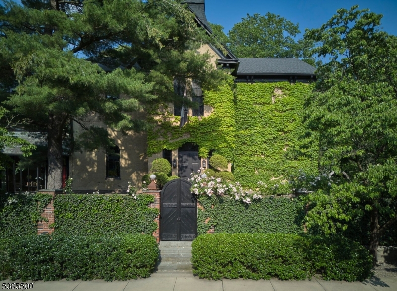 The Historic Italianate Schoolhouse is a one-of-a-kind residence where art, architecture, and modern living converge. Built in 1878 as Lambertville's First Ward School and reimagined over four years by New York art collectors, this 5,500 sq ft, 4-bedroom, 3.5-bath home blends preserved craftsmanship with state-of-the-art systems. The sweeping three-story staircase and cabinetry by Paul Evans remain, while updated mechanicals, Lutron lighting, and new windows ensure comfort and efficiency. Inside, 12-foot ceilings and oversized windows flood the home with light. The grand foyer leads to a living room with fireplace, wet bar, art gallery, and library/dining room. A wood-paneled sunroom opens to a private, illuminated walled garden by Buck Walter, with slate and granite hardscaping, multiple seating areas, secret garden, and parking for six plus an attached garage. The gourmet kitchen features top appliances, a large island, and custom commercial hood.The third floor offers a south-facing primary suite with sitting room, dressing area, and luxury bath with Fornasetti wallpaper and antique fixtures, plus two additional bedrooms. A fourth-floor private suite and an attic with climate-controlled gym add flexibility. Combining historic elegance with modern convenience, this rare property is both a home and a living work of art in the heart of Lambertville. Home is also available fully furnished.