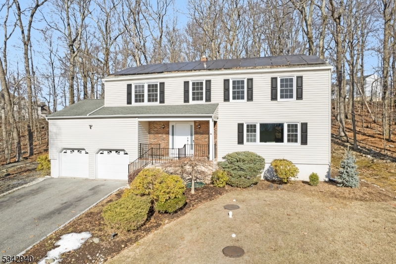 Welcome to this charming colonial home, perfectly situated at the end of a peaceful cul-de-sac in Budd Lake. This spacious 4-bedroom, 2.5-bathroom residence offers a blend of classic elegance and modern updates, providing the ideal space for comfortable living. The bright and airy layout includes a spacious primary suite, complete with a large walk-in closet and a private bathroom. The updated main bathroom (2023) adds a modern touch, ensuring convenience for all. The updated kitchen includes a Viking range and granite counters. Just beyond the breakfast bar sits the family Room with a wood burning fire for perfect cozy evenings. Step outside through the sliding doors to a lovely back deck, perfect for entertaining or enjoying peaceful moments outdoors. The expanded 2-car garage features tall ceilings, providing plenty of room for storage or additional workspace. Enjoy the extra space provided in the basement for a rec room, home gym or office, in addition to extra storage. The home has been well maintained with fresh paint throughout, new Living Room carpet, new radon pump in 2024, and all utilities regularly serviced. Owners will pay off solar lease prior to closing and buyers will own out right, with maintenance continuing through March 2027.