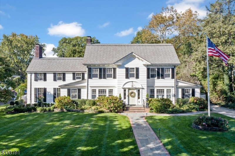 American classic center hall Colonial set on one of the largest lots that Glen Ridge has to offer. This beautiful home is a dream come true with extensive upgrades & renovations throughout and the perfect open floor plan for all to enjoy. The timeless aesthetic offers elegance combined with modern living. Gourmet Cooks' kitchen with quartz countertops, large island, Wolf double ovens & 6-burner gas-range, Sub Zero fridge plus fridge drawers & 2 wine fridges, butler's pantry and desk, 2 family rooms, mahogany paneled media room with bar, office, large dining room, large living room, powder room & mud room complete the first fl. 2nd fl features primary suite with over-sized bath with soaking tub, shower, double sinks, radiant heat & walk-in closet, 4 additional bedrooms, one with ensuite bath, & a hall bath. 3rd fl has large bedroom, marble bath, laundry & lots of storage. 2 basements, one with outside entrance, wine closet, laundry, powder room & rec room, other with pool room and decorative fireplace, both with storage. Special features include lots of custom molding, built ins, window seats, hardwood floors, multi-zone cooling & heating, flat yard with pergola, bluestone patio, grill hook-up, fence, sprinkler system. 3-car over-sized garage with loft. Home of so many traditions, GR project graduation, bridal showers, weddings, fundraisers. Close to Walnut Street train station, Farmer's Market, Cafe's, GR top rated schools. Make your own memories in this special home!