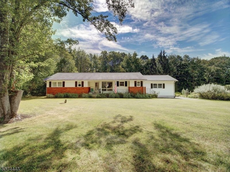 Welcome home to this beautifully maintained 3-bedroom, 1.5-bath ranch offering the ease of one-floor living on a stunning, private lot. Pride of ownership shines throughout this beautifully maintained home. Neutral d cor, abundant natural light, and carefully selected finishes provide a fresh, modern feel while creating a warm and inviting space you'll love coming home to. This beauty is nestled on over half an acre of picturesque, park-like grounds, this home combines comfort, functionality, and outdoor beauty.  The renovated, sun filled kitchen is dreamy...quartz countertops & backsplash, tile flooring, beautiful cabinetry & stainless steal appliances. The living room & dining room have an open concept, beautiful wood flooring and sliding glass doors leading to a Trex deck, creating a seamless blend of indoor and outdoor living.The Trex deck overlooks the expansive yard and is perfect for entertaining or just relaxing outside. Bedrooms are generously sized. Additional highlights include wood flooring, two car side garage, half finished basement perfect for recreation, work-from-home, fitness, & storage space. Conveniently located just mins to shopping, dining, schools, parks and commuter routes. A must see