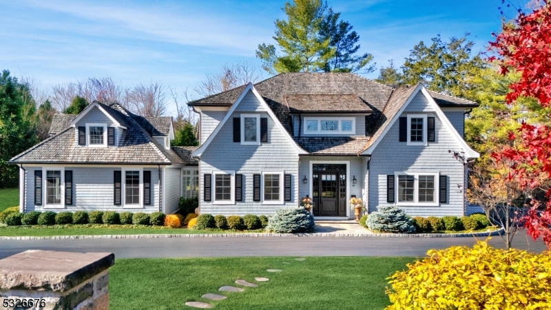 Built in 2017, this upscale residence offers a lifestyle of luxury and comfort, ideally situated on a flat, private 2/3-acre lot on one of the most coveted streets in Old Short Hills. Thanks to local architect Tom Baio AIA, generous windows and French doors offer plenty of natural light while 10-foot ceilings provide an airy and expansive feel. Refined by renowned interior designer Robin Gannon, luxurious bespoke finishes and built-ins are what make this home truly special, with unparalleled attention to detail in every room. The gourmet kitchen, with two large islands and top-tier appliances, flows seamlessly into the fireside family room, creating an ideal space for both relaxation and entertainment. The first floor also features a private office/in-law suite with separate entrance. Upstairs, the magnificent primary suite includes a fireplace, custom walk-in closets, and a spa-like bath. Four additional bedrooms and a laundry center complete the second floor. The third-floor loft includes a full bath, while the beautifully finished lower level has high ceilings, a generous recreation room, exercise room, bedroom suite and storage room. A first floor heated 3-car garage adds convenience, while the private backyard with bluestone patio provides ample space for entertainment. Conveniently located just 1 mile from the Short Hills Train Station and top ranked Hartshorn elementary school, this home is a true sanctuary in this highly sought-after community.