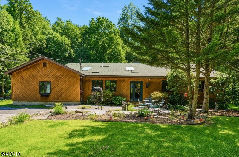 Set on a 1 acre in Culver Lake, this Home offers approximately 2,200 square feet featuring 3 bedrooms, 2.5 baths, an attached 2-car garage, and an easy flow floor plan enhanced by multiple skylights that fill the home with natural light. The true highlight is the exceptional outdoor setting, where mature trees create a private backdrop for a resort-style backyard complete with an in-ground pool, a poolside gazebo,  ideal for entertaining or simply enjoying the peaceful surroundings. Whether hosting summer celebrations, relaxing poolside, or enjoying a quiet morning coffee immersed in nature, this property offers a rare combination of privacy, outdoor living, and everyday comfort. Conveniently located just minutes from shopping, dining, recreation, and commuter routes, this is a unique opportunity to enjoy a home that feels like a getaway while remaining close to everything you need.