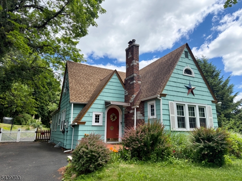 This charming Tudor-influenced Cape Cod is nestled on a half-acre in the heart of Watchung. This 4-bedroom, 2-bath home combines storybook curb appeal with practical living, featuring sun-filled rooms, warm hardwood floors, and a comfortable, flexible layout. The inviting front entry opens to a cozy living area and an updated kitchen. At the same time, the finished lower level offers ideal space for a playroom, home office, gym, or media room. Outdoors, mature landscaping, flowering beds, and a level yard create a private, park-like setting perfect for relaxing or entertaining. Convenient to major commuting routes, shopping, and dining, 72 Hillcrest Rd offers a rare mix of character, space, and location ready for its next owner to make it their own.