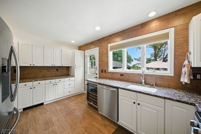 True Pride of ownership in this custom and charming home! Beautiful hardwood flooring. Lovely Architectural Features throughout, gives this Home a custom Lake Cottage Feel! Stunning kitchen with breakfast bar, pantry and stainless steel appliances. Open dining area with fireplace and a bright, large living room with multiple windows and tons of natural light. Convenient first floor powder room and mudroom. Office with french doors. Upstairs, a primary bedroom offers an en-suite bath. 2 additional bedrooms and an updated full bath with tub shower. Convenient laundry room. Full, partially finished basement accessed by spiral staircase. Neutral colors throughout. Super-sized garage. Beautifully landscaped back area with paver patio and pergola. Tremendous curb appeal! Enjoy all that Indian Lake has to offer. Fantastic location; walking distance to Indian Lake Bistro, ILCC Clubhouse, beaches, swimming, boating, playground & fun! Mins from DWTN Denville, NYC commuter locations for both bus & trains. Top Schools! House has been meticulously maintained.