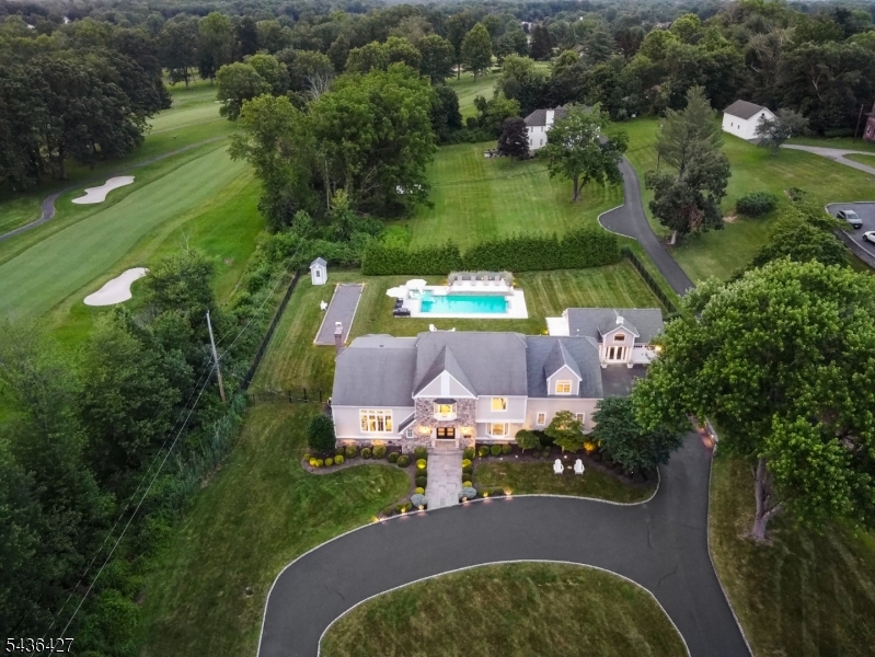 Exceptional custom estate on over 1 acre and close to the NYC Midtown Direct train that offers a lifestyle unlike any other! Luxury, recreation, and timeless elegance come together in a truly remarkable setting. The spectacular outdoor setting is truly an entertainer's dream, featuring a stunning gunite pool with cascading waterfalls, expansive patios, lush grounds, and a private bocce court   creating the ultimate summer retreat. Inside, the home continues to impress with a sophisticated indoor wet bar and lounge area, ideal for hosting throughout the winter months. The gourmet indoor and outdoor kitchens are equipped with top-of-the-line appliances, highlighted by a coveted La Cornue range, offering a chef-inspired culinary experience both inside and out. The luxurious primary suite serves as a private sanctuary, complete with dual spa-like bathrooms, two separate walk-in closets, and a contemporary juliet balcony overlooking breathtaking views of the pool and golf course at Brooklake Country Club. A versatile detached structure offers endless possibilities and can easily function as a garage, pool house, gym, entertainment space, studio, or guest retreat. Additional features include a whole-house generator for added comfort and peace of mind. All of this, combined with the benefit of low Florham Park taxes, makes this exceptional property an unparalleled offering.