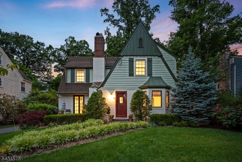 Beautifully renovated, impeccably maintained, classic Colonial Tudor blends timeless character, modern luxury, lush private gardens & exceptional convenience in coveted Glenwood.Just steps to Hartshorn Arboretum, 2 blocks to Midtown Direct NYC train, & .6 to Glenwood Elementary, .8 to Millburn High, the home offers a rare combination of charm, lifestyle, & everyday ease.A gracious entry vestibule opens to a warm & inviting living rm w/gas fireplc, built-in bookcase & French drs leading to charming front patio.Formal dining rm, framed by a bay window, creates an elegant setting. At the heart of the home, the renovated eat-in kitchen features custom white cabinetry, quartz countertops, marble backsplash, premium S/Sl appliances, incl Thermador 6-burner gas range, refrigerator, & DW, beverage center w/Marvel refrigerator, center island w/Sharp microwave, & sun-filled breakfast area w/skylights & wall of glass overlooking covered patio & private perennial gardens.The 1st flr also offers a flexible family rm w/gas fireplce & access to a beautifully renovated full marble bath w/glass-enclosed shower, subway tile, & marble basket-weave floor-ideal office, guest retreat, or Bedroom Option 5. On 2nd flr, 4 well-appointed bedrooms & 2 newer marble baths incl a serene primary suite w/double sinks & oversized glass-enclosed shower.Convenient laundry rm w/sink adds everyday ease.Finished lower lev provides rec rm, office or Bedroom 6 Option, storage rm w/sink, utilities. 2-car det garage.