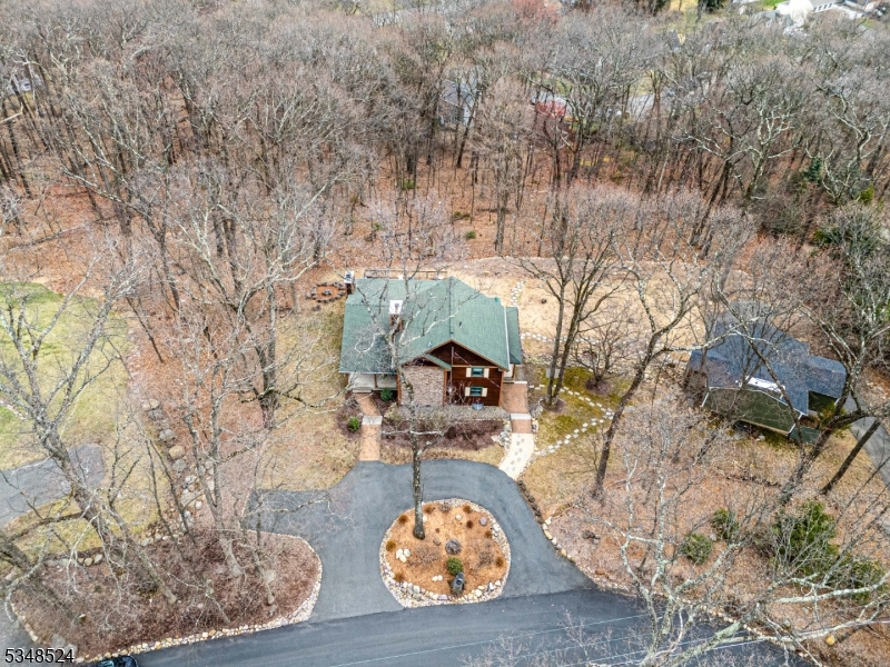 Custom, Renovated Home Beautifully Situated on 1+ Wooded Acre! This unique property offers an impressive 2500 sqft home PLUS a stunning, detached studio GUEST HOUSE w/4th full bath. The main house includes a gorgeous oversized fireplace, wall of windows & french doors, high ceilings all create a grand space! Renovated Chef-grade Kitchen offers center island +super sized pantry. The perfect kitchen to host parties or create gourmet meals for your friends & fam! SS appliances, 6 burner propane gas stove & 2 wall ovens. Granite counter, cherry cabinets. Dual laundry room & butler's pantry with wine fridge. Formal dining, great layout for entertaining. Upstairs, a primary suite with bath & walk-in. Customized closets in all bedrooms! Expansive finished bsmt; rec room with pool table, the third bdrm & full bath. Detached 2 garage, work room & recently renovated top to bottom guest house. Oversized deck. Lovely perennial & wildflower gardens throughout the property. This home accentuates peaceful, nature living yet the conveniences of living in Denville, the Hub Of Morris Co. Close to NYC-Direct transit, easy access to highways, bustling & thriving Downtown & TOP schools. NEW 5 bedroom septic system to accommodate both buildings. 2 Zone Central Air & NEW Boiler. Cat6 network cabling on both main house & guest house to provide fast internet. 3 outside Wi-Fi access points to provide fast internet while outside in the yard, on the 3 porches & on the deck. Nat gas hookup on street!