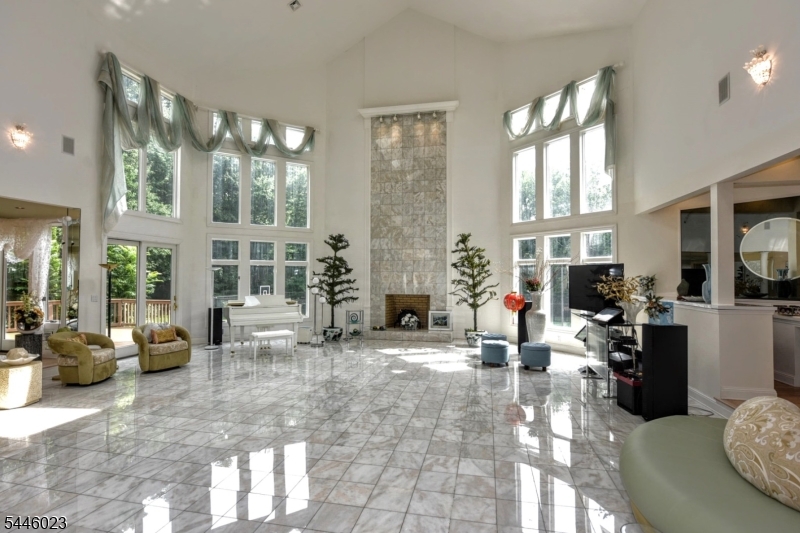 Prepare to be impressed! Drawing from the natural beauty of its surroundings, this spectacular custom-built estate is perfectly placed on 2.8 magnificent, lush private acres. Located in the prestigious, sought-after area of Burning Hollow, w/excellent supporting values, this incredible manor has it all! From the circular drive w/lovely free-form pond and falls, step through the attractive leaded-glass doors onto an expanse of polished marble flooring to find a breathtaking, lofty space. Illuminated w/natural light from 8 skylights, the LR features two-story soaring ceilings and floor-to-ceiling marble FPL. Open to the DR, den, and bar, this commodious area is ideal for large-scale entertaining. Experience over 10K SF of luxury living at its best w/a gourmet kitchen w/FPL and grand MBR w/private terrace, his-and-her walk-in closets, and baths! Enjoy the view from the fabulous free-floating balcony, and the convenience and appeal of an elevator, back staircase, and 10' ceilings on all 3 levels. Decking leads to the beautifully landscaped, gated, oversized rear grounds, which easily accommodate both the sparkling in-ground pool and tennis/basketball court. Along with its 4-car attached garage and municipal water, it is truly a rare find. Located just minutes to NYC, major rtes, shops, and fine dining, Saddle River offers its residents majestic homes and rural beauty, along w/highly rated schools and low taxes. You will not want to miss this exquisite estate. Opportunity knocks!
