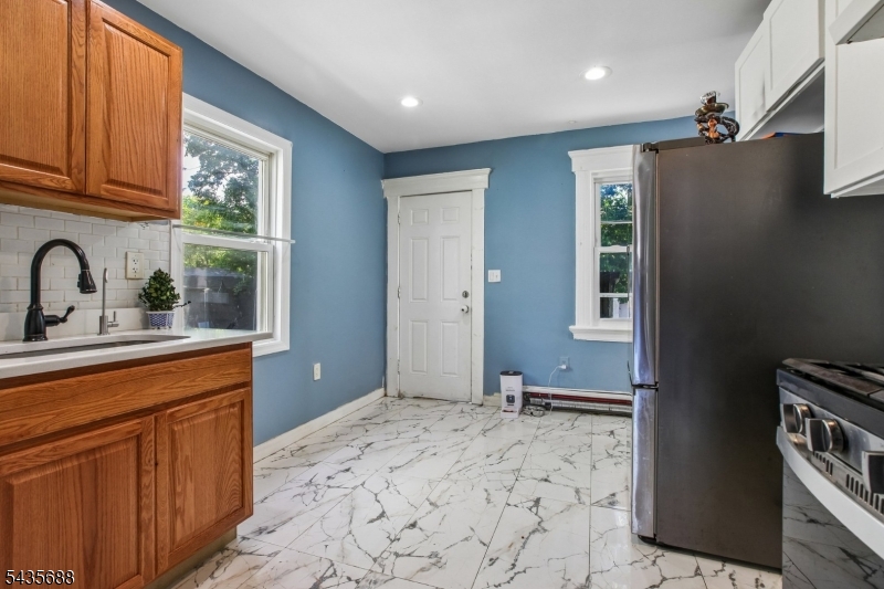 Welcome to this spacious Colonial-style home located in the heart of East Orange. This property offers 6 generously sized bedrooms and 3.5 bathrooms, including two bedrooms with private en-suite full baths, providing comfort and flexibility for extended living arrangements. The home features a spacious living room and formal dining room, ideal for entertaining and everyday living. A full basement with a partially finished area offers additional usable space with endless possibilities. Outside, enjoy a large backyard perfect for gatherings, recreation, or gardening, along with a private driveway that accommodates at least 3 cars. The roof is approximately 7 years old. Property is being sold strictly in as-is condition. Conveniently located near schools, shopping, transportation, and major highways. Don't miss this opportunity to own a large home with tremendous potential. Buyer is responsible for the Certificate of Occupancy.