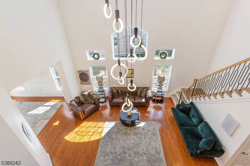 Bright, modern, and spacious 5-bedroom, 3-bath home offering 3,300 sq ft of luxurious living in the highly desirable Bluffs at Ballyowen. This beautifully maintained 2-story brick-front residence features an open-concept layout that's both inviting and functional. The soaring cathedral ceiling in the LR fills the space with natural light, creating a bright and elegant ambiance. At the heart of the home is a fully renovated chef's kitchen, showcasing a 10-foot quartz island with dual waterfall edges, dual deep-countertop refrigerators, sleek modern cabinetry, and a sliding glass door leading to patio, perfect for seamless indoor-outdoor entertaining. Enjoy the privacy and convenience of a 1st-floor master suite, complete with two walk-in closets. Two additional bedrooms, a fully renovated bathroom, a formal dining room, and a laundry room complete the main level. Upstairs open loft lounge overlooks the living space and entry, accompanied by two oversized bedrooms, walk-in closet and a 4-piece bathroom featuring radiant floors. Thoughtful modern finishes enhance the home's style and comfort throughout. Huge storage space above garage.Community amenities are only 40 steps away and include access to a heated saltwater outdoor pool, clubhouse with fitness center and party room. Landscaping and snow removal provided by HOA. This exceptional home seamlessly blends luxury, comfort, and convenience.