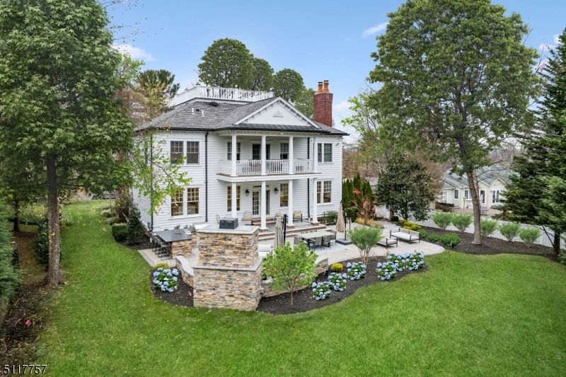 Experience upscale lifestyle and understated elegance in this newly renovated six bedroom residence that offers everything that home buyer's want today, including architectural interest, an open floor plan with great flow, plenty of sunlight and a home situated just blocks to town, train and schools in the sought after Hill section of Madison. Towering ceilings, striking millwork, grand entry foyer with sweeping staircase, new white gourmet kitchen, banquet size dining room, fireside master suite with balcony, two walk-in closets and luxurious new spa-like bath with free standing tub and steam shower sure to sooth the senses. There are five additional bedrooms on the second floor, a new outdoor kitchen with sink, fridge, built in barbecue, large patio and gas fireplace, a newly renovated basement with recreation room and exercise room, three car garage, four fireplaces, and so much more! This stunning home was built by a prominent local builder and is beautifully decorated by a renowned decorator boasting a designer palette, top of the line lighting, wallpaper and finishings. You are sure to enjoy this spectacular home and all Madison has to offer, recently rated #1 Town to Live in by NJ Monthly. Don't miss this rare opportunity!