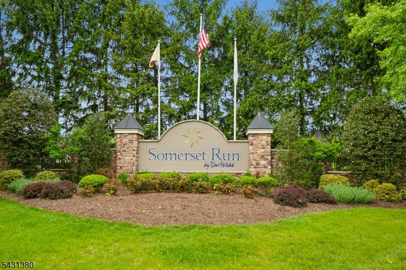 Welcome to Somerset Run's premier 55+ gated community! This beautifully maintained first-floor condo offers effortless one-level living with 2 spacious bedrooms, 2 full baths, plus a versatile den/home office. Bright and open floor plan featuring a large living and dining area with direct access to a private balcony overlooking peaceful wooded views and a quiet cul-de-sac. Eat-in kitchen includes 42  cabinetry, ample counter space, and pantry.  Spacious primary suite offers tray ceiling, walk-in closet, and en-suite bath with double vanity and stall shower. Separate guest bedroom and bath provide ideal privacy for visitors. Additional highlights include in-unit laundry, extra storage, underground assigned parking close to elevator access, and abundant guest parking. Enjoy resort-style amenities including a 25,000 sq ft clubhouse, indoor/outdoor pools, fitness center, tennis/pickleball courts, bocce, sauna, walking paths, social activities, and 24-hour gated security. Conveniently located near major highways, shopping, dining, and Rutgers/New Brunswick area. Move-in ready and maintenance-free living at its finest!