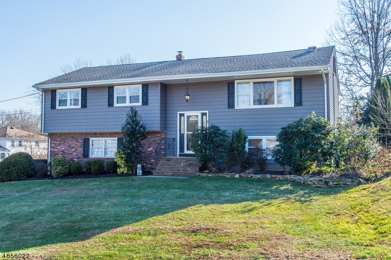 This quintessential neighborhood home is sure to exceed your expectations. Updated eat-in kitchen with granite counters, custom cabinetry, tile floor and breakfast bar. All bathrooms have been nicely updated; wood floors throughout main floor; Master bedrm has attached full bath. Walk-out lower level boasts family room w tile flr, laundry rm with custom cabinets, sink and granite counter and updated powder room.  You'll want to vacation at home in the gorgeous, fenced backyard highlighted by an in ground pool and patio with custom awning. Nicely landscaped with underground sprinkler system.  The home is well-maintained with many newer updates including: roof, siding, and most windows. Great location close to commuter routes, stores, restaurants, parks and the elem, middle & HS are within 3 mi drive approx.