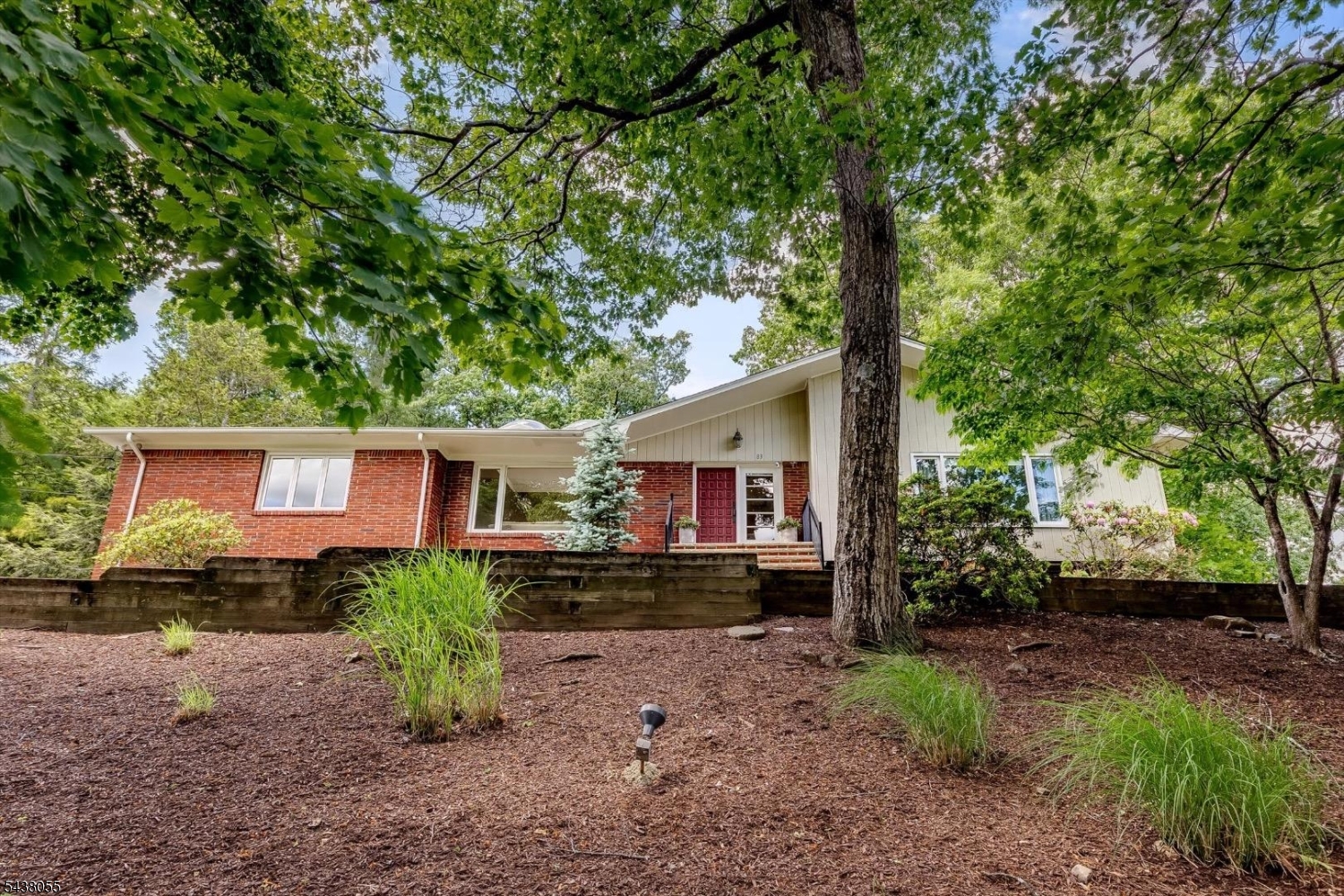 Welcome home to this beautifully updated ranch, where comfort, elegance, and easy living come together. Nestled on a lovely wooded property, this inviting home offers a spacious and thoughtfully designed floor plan filled with natural light.The updated kitchen serves as the heart of the home, featuring a dining area and sliding doors that open to a private patio perfect for morning coffee, outdoor dining, or simply enjoying the peaceful surroundings. The sun-filled living room boasts vaulted ceilings, skylights, and expansive picture windows, while the cozy family room features a striking stone fireplace and skylight, creating the perfect gathering space year-round.Retreat to the spacious primary suite, complete with two oversized closets and a beautifully renovated en-suite bath. Three additional generously sized bedrooms, a formal dining room with dramatic floor-to-ceiling windows, a large welcoming foyer, and first-floor laundry provide both comfort and convenience.The finished lower level offers a versatile recreation room, abundant storage, a cedar closet, and crawl space. Combining timeless charm with modern updates, this exceptional home is ready to welcome its next owners.