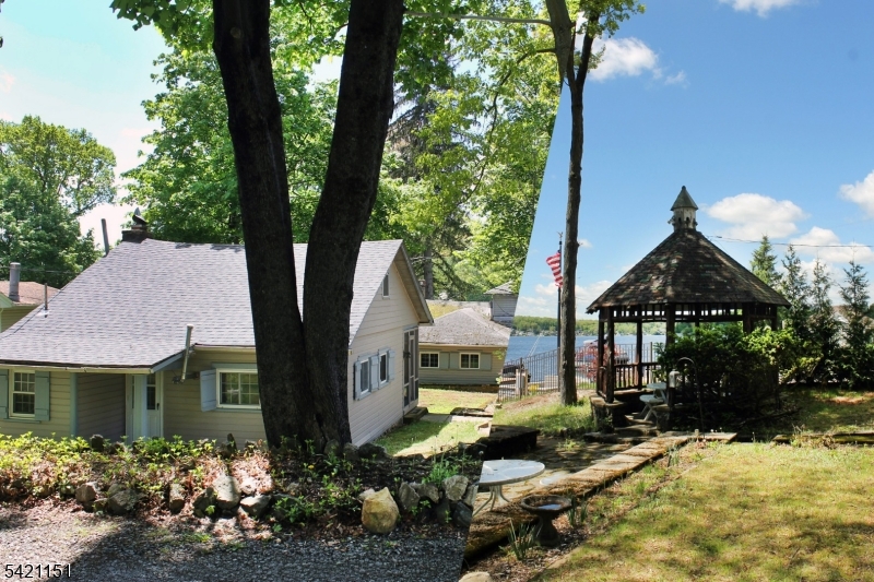 Location, location, location! Rare prime lake front investment property with two houses, private sandy beach, patio with gazebo, dock, boat house, southern exposure and sunset views!