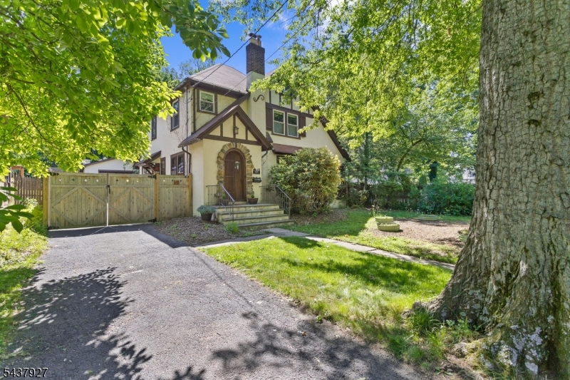 Welcome to this beautifully renovated 1929 Tudor-style home, ideally situated near the sought-after Netherwood Heights Historic District. Blending classic architectural charm with thoughtful modern updates, this home offers both character and convenience. The custom-designed kitchen features premium appliances, stylish cabinetry, and a charming breakfast nook perfect for casual dining. The warm and inviting living room is highlighted by a wood-burning fireplace, while the sun-filled enclosed porch provides an ideal space for relaxing, working from home, or enjoying your morning coffee.The second level offers three spacious bedrooms and a full bath, along with access to a large walk-up attic via a permanent staircase, presenting excellent storage or future finishing possibilities. The finished lower level includes a dedicated home theater and versatile bonus space suitable for a home office, fitness area, or recreation room. Outside, the fully fenced backyard creates a private retreat for entertaining, gardening, or simply unwinding. Conveniently located near major highways, approximately 26 miles from New York City and 13 miles from Newark Liberty International Airport, this move-in-ready home offers the perfect balance of historic elegance and modern living.