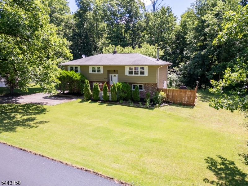 Beautifully renovated and move-in ready, this stunning home in Andover Township offers 4 bedrooms, 2.5 baths and an open floor plan situated on just over a half-acre of level property. The updated kitchen features granite countertops, white cabinetry, and tile flooring, while the dining and family rooms showcase gorgeous hardwood floors. The first floor features a warm and inviting family room with a cozy wood-burning fireplace, creating the perfect space to relax and entertain. The lower level offers an additional bedroom, another family room, laundry area, and access to the oversized two-car garage. Outside, the flat yard and beautiful curb appeal make this property truly stand out. With plenty of space both inside and out, all that's left to do is move right in and enjoy your new home. NEW GARAGE DOORS, KITCHEN TILE FLOOR, DISHWASER, WATER SOFTNER, PAINT RFRESH IN HOUSE AND OUTSIDE, FRONT DECK FLOORING, PAINT ON DECK STAIRS, NEW SHADES IN ALL OF HOUSE. Close proximity to Lake Lenape. Buyer may apply for membership to Lake Lenape association. Schedule your private showing today!