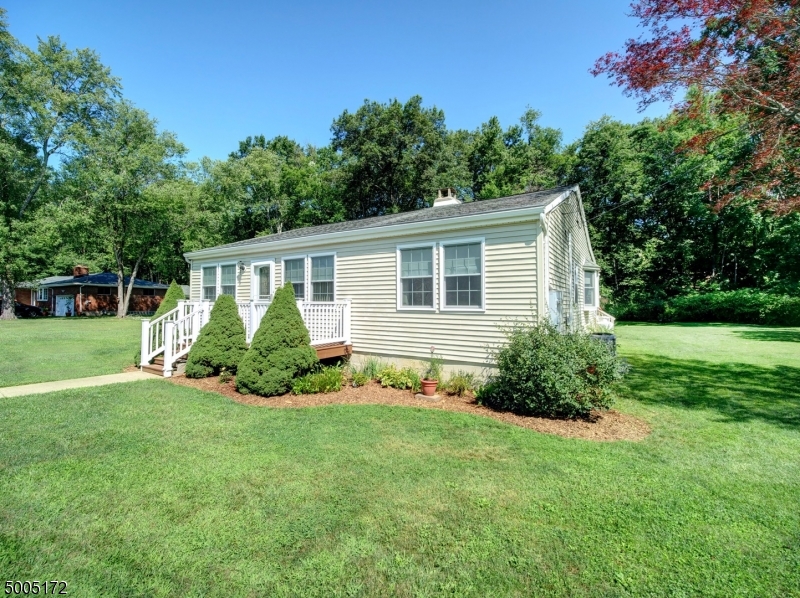 WELCOME HOME TO THIS MOVE-IN READY, BRIGHT & AIRY, 3 BEDROOM, 2 FULL BATH RANCH WITH COVERED & ENCLOSED SCREEN PORCH! ENTER THRU GENEROUS SIZED LIVING ROOM-DINING ROOM COMBO W/ WOOD BURNING FP. SPACIOUS, NEWER EAT-IN KITCHEN LEADS OUT TO ENCLOSED DECK & A TREE-LINED YARD, WITH PROTECTED LANDS--GREAT FOR ENTERTAINING. MASTER BEDROOM ENSUITE WITH JACUZZI BATHTUB AND SHOWER STALL. SECOND BATH FEATURES AMERICAN STANDARD WALK-IN TUB. BRAND NEW CARPETING & FRESHLY PAINTED THROUGHOUT.  ABUNDANT CLOSET SPACE! BRAND NEW BOILER FURNACE (JUNE 2020) AND OVERSIZED 2-CAR DETACHED GARAGE WITH LOFT STORAGE. STACKABLE WASHER / DRYER CLOSET RIGHT OFF KITCHEN.  YOU'LL NEVER BE WITHOUT ELECTRICITY WITH THE FULL HOME GENERATOR!