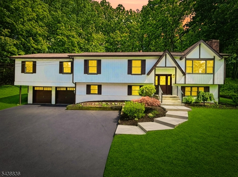 Beautifully updated 4 bed, 2 bath expanded bilevel offering over 3,000+ sqft of finished living space on a stunning naturally landscaped lot with gorgeous mountain views. Sun-filled interior features refinished natural hardwood floors throughout the main level and two fireplaces for year-round comfort.The updated kitchen boasts new cabinetry, quartz countertops & backsplash, and stainless steel appliances. The expansive 1,000 sqft deck with three separate entrances is perfect for entertaining and outdoor living.The oversized primary suite includes a sitting room/home office, French doors, generous closet space, private deck access, and a spa-like bath with soaking tub and separate shower. Spacious bedrooms feature double closets throughout.The fully finished lower level offers incredible flexibility with a large family room featuring a wet-bar kitchenette w/ wine cooler, fireplace, oversized recreation room, additional bedroom, secondary laundry hookup, with potential for an in-law suite or extended living space.Additional highlights include high-efficiency HVAC w/ central A/C & forced hot air, supplemental baseboard heat with separate zones, 2x6 construction for low utility costs, walk-up attic with abundant storage, and a 2-car garage with workshop cabinetry. Outside you'll find new garage doors, fascia, soffits, stairs, walkway, refreshed deck, and more. Conveniently located near commuter routes, shopping, farms, and Skylands Stadium, and only 1 hour from NYC. (3BD Septic)