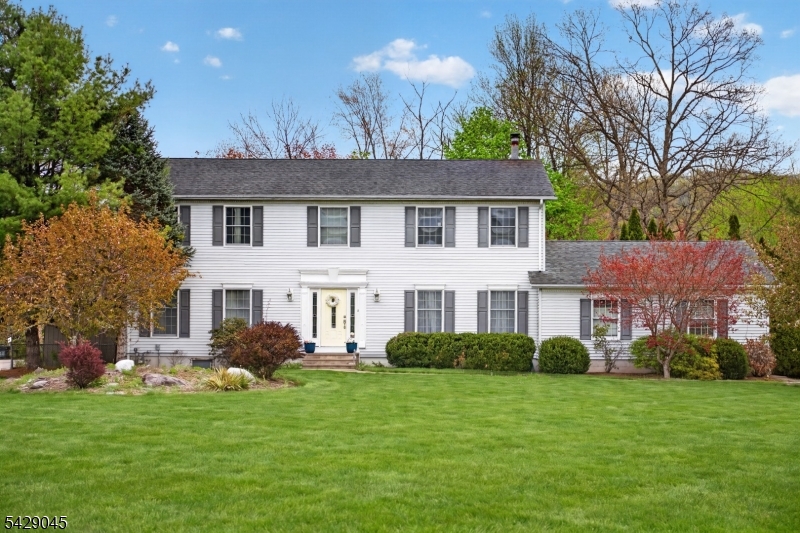 This sprawling 4 bed, 2.1 bath colonial offers the perfect blend of modern efficiency and serene outdoor living. Boasting 2,818 square feet of space, plus a finished walk-out basement, this home is designed for both scale and comfort, situated on a private, dead-end street. The main level features gleaming hardwood floors and a bright kitchen equipped with a center island and a large pantry. The highlight of the home is the incredible four-season sunroom offering a year round vantage point of the private grounds. Upstairs the massive primary suite serves as a true sanctuary complete with a walk-in closet and an ensuite bath featuring double sinks a soaking tub and a stall shower. Three additional large bedrooms provide ample space for everyone. The lower level adds even more versatile living area featuring a cozy pellet stove, additional office space, and a walk out to the backyard. Relax by the tranquil stream or spend summers lounging by the above-ground pool. Major updates include a septic system replaced in 2021 a newer boiler, natural gas, central air, and public water. This home also features an attached two car garage.