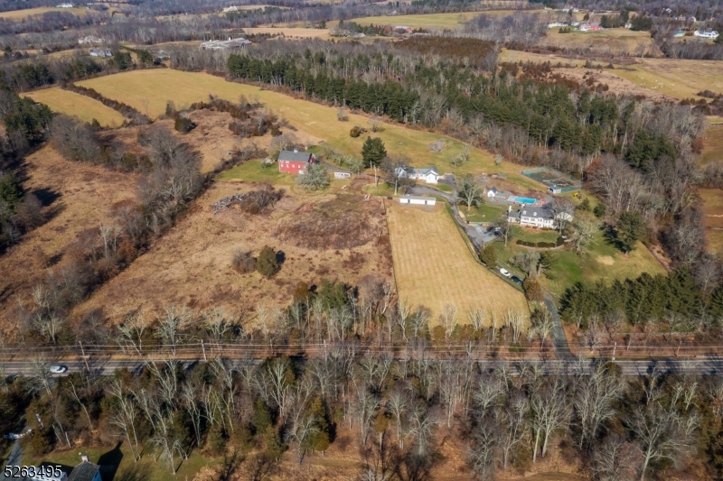 A rare opportunity in Bedminster Hunt Country to own 83+/- acres in a sought-after location. The lush and gently rolling landscape is open and wooded with expansive fields, pastures, spacious lawns and stone walls. The property is farm assessed and has possible subdivision potential and/or preservation potential. The compound currently includes a 5 BR farmhouse with detached 2 car garage (currently used as a gym) a spacious cottage w/ 3 car garage, 4 connected run-in sheds with paddock, a large  gambrel roofed red "party" barn with an attached 2 bedroom / 2 Bath caretaker apartment and tractor garage underneath . There is a new pool (deck needs to be completed), pool shed, tennis court and tennis shed.  The property is being SOLD "As Is"                                         (farm house interior photos to come )
