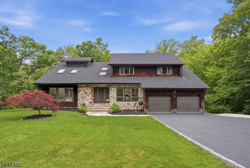 Spacious, updated, and full of character, this impressive 5-bedroom, 4.5-bath contemporary is set on a beautiful, private property in desirable Sparta. Soaring ceilings, oversized windows, skylights, and an abundance of natural light create a bright, open feel throughout. The main level is ideal for both everyday living and entertaining, featuring multiple living areas, a spacious eat-in kitchen, formal dining room, first-floor office or 5th bedroom, and an incredible family room complete with a custom wet bar and floor-to-ceiling stone fireplace. Upstairs, the primary suite features vaulted ceilings, a private balcony, and a beautifully updated spa-like bath, while three additional generously sized bedrooms complete the second floor. The fully finished walkout basement has been updated with new luxury vinyl flooring and includes a full bath, offering endless possibilities for a recreation room, home gym, media room, guest suite, or additional living space. The home was also recently converted to natural gas for added efficiency and convenience. Enjoy the expansive rear deck overlooking the private backyard, all just minutes from Downtown Sparta's shopping, restaurants, and local amenities, with easy access to Routes 15 and 23 for commuters.