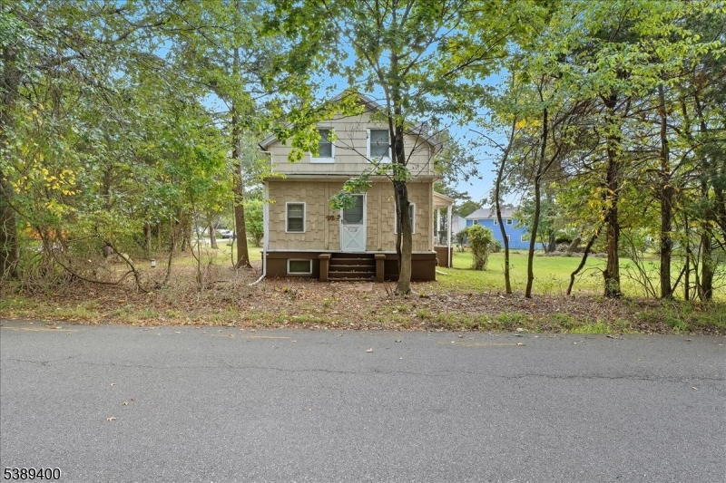 Welcome to this rare renovation opportunity on a spacious corner lot just minutes from Rutgers University's College Avenue Campus. Ideal for investors, developers, or buyers ready to update a home and bring their vision to life. The first floor features a generous living room with hardwood floors, a versatile bedroom or office, a kitchen, a full bath, and an additional room off the kitchen that could easily become another bedroom. Upstairs, you'll find three bedrooms with the option to restore the original four-bedroom layout, a half bath, and a storage closet. The unfinished basement houses all utilities, including a new boiler installed a few months ago, an above-ground oil tank, water heater, and well water filtration system, with a Bilco door providing convenient outdoor access. Outside, the property offers a detached one-car garage and a large yard with room to expand, perfect for outdoor living or future improvements. Conveniently located near Rutgers University, major highways, shopping, and local schools. The home is being sold strictly as-is.