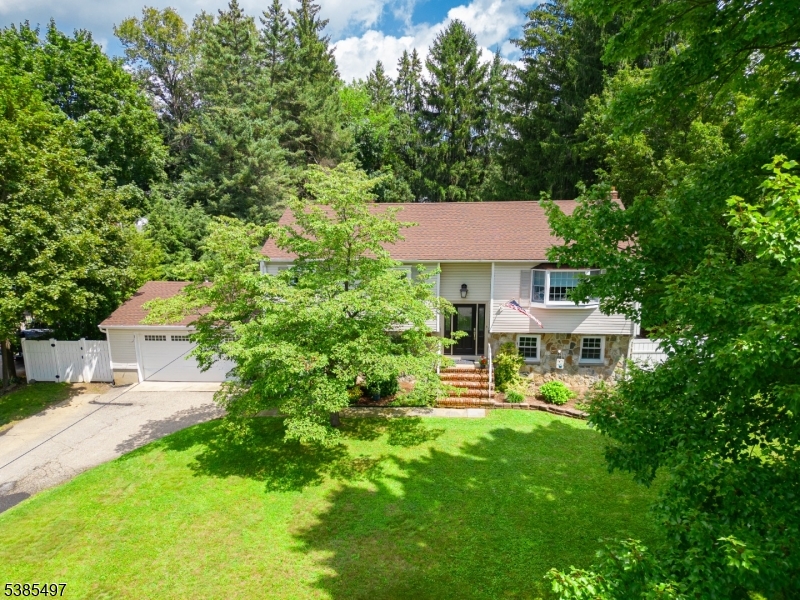 O P E N House Canceled! Welcome to this beautifully maintained 4-bedroom, 2-bath bi-level home, offering style, comfort, and plenty of space for everyday living. The upper level features hardwood flooring throughout, enhancing the warm and inviting feel. An updated kitchen boasts rich maple cabinets, sleek granite countertops, and flows seamlessly into the open dining area with recessed lighting. A sliding glass door leads to a spacious composite deck perfect for outdoor dining or relaxing. Three generously sized bedrooms are located on the upper level, each with large closets, while the fourth bedroom is privately situated on the lower level. The ground floor also showcases an oversized living space created by extending the garage, offering the perfect setting for a family room, entertainment lounge, or play area. Both bathrooms have been tastefully updated with modern tile flooring and finishes. Outside, enjoy your own private, fenced-in backyard oasis featuring an in-ground pool with a new liner installed in 2022. An attached 2-car garage completes this wonderful home. Garage fridge stays