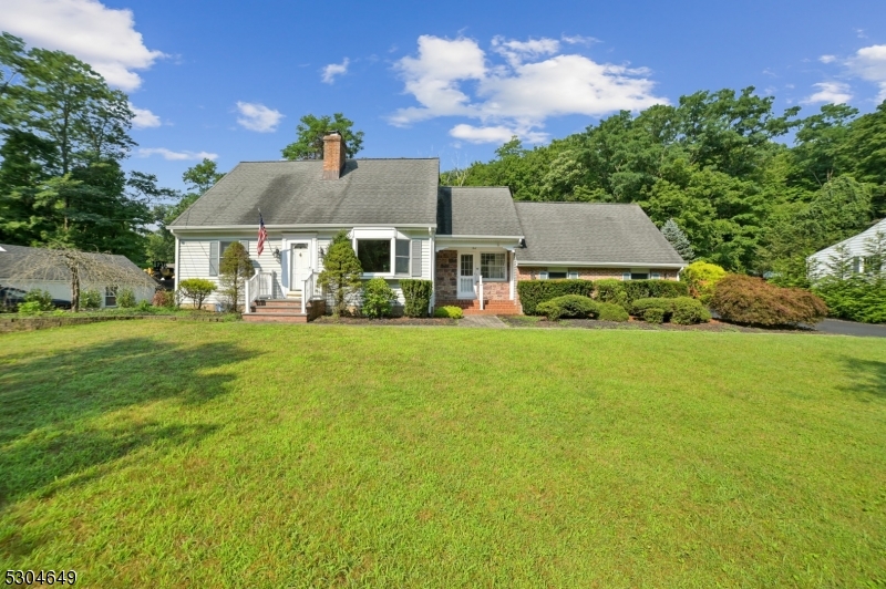 Nestled in sought-after Boonton Township, this Cape Cod home checks all the boxes. Featuring 4 bedrooms and 3 bathrooms, this property offers the convenience of public utilities and the serenity of a 1-acre lot. The home has a full finished basement with a wood stove and bar, perfect for entertaining and a paver patio for your next outdoor gathering. The two-car garage with walkup loft storage provides ample space for all your hobbies.  Additional parking ensures convenience for guests. This home is located near shopping and highways where you'll enjoy easy access to everything while still relishing the country-like setting.