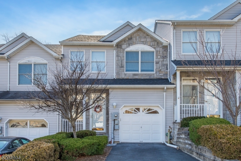 Move-in ready 2 bedroom 2 1/2 bath home in Glenmont Commons in Parsippany. You are welcomed into the 2 story foyer with oak hardwood floors and natural light. The open floor plan links the dining room, living room and kitchen. The living room has a wood burning fireplace as well as sliding doors to the deck with views to the wooded area beyond the complex. The kitchen offers granite counter tops and stainless steel appliances, including a refrigerator, 5-burner gas stove, microwave and dishwasher. A powder room and garage entry complete the main level. Upstairs are two spacious bedrooms both with walk in closets and en-suite bathrooms. The basement offers amble storage space and is a walkout that leads to the private backyard with hedges on both sides of the yard area. The home has a one car garage and its own driveway (not shared). The home provides easy access to shopping areas, restaurants and major highways. Home is located in Parsippany and is part of the Parsippany School District with a Morris Plains mailing address.