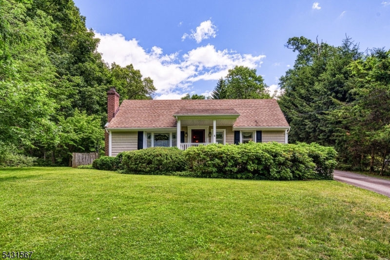 This charming country 3 Bedroom 2 Bath Ranch is set back and poised on a very private tranquil 1.7 Acre lot featuring a spacious Living Room with a curved fieldstone gas fireplace and built-in shelving, a Formal Dining Room with crown molding, chair rail, and storage. Updated eat-in Kitchen with skylight, hickory wood cabinets with Shaker style doors, and granite countertops 2012. First-floor laundry, Bedroom/Office with crown molding. Primary bedroom with slider to deck. Renovated Baths 2012. Solid pine six-panel doors. Some oak hardwood floors. Generous two-level Trex deck with a retracable awning for gracious entertaining and relaxation. Mature plantings and open rear yard.  Oversized three-car garage with electricity, workbench, and an additional carport (Big Top) for the car enthusiast. Newer kitchen and baths, Boiler with two-zone natural gas-fired baseboard heat 2024, water heater 2022, and a whole-house generator for year-round comfort are all features of this well-maintained home.  Don't miss the opportunity to make this well-maintained home your own.