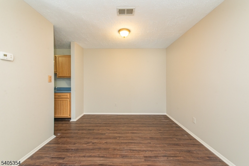 Don't miss out on this rare two bedroom, two full bath ranch style unit in The Meadows that backs up to the woods! The bright, open layout features vinyl flooring throughout the main living areas and cozy carpeted bedrooms, along with plenty of closet space, including a spacious walk-in closet. The well-appointed kitchen comes equipped with a gas stove, refrigerator, and dishwasher, while the living room offers a gas fireplace and opens through sliding glass doors to a back patio, perfect for relaxing or entertaining. Additional highlights include forced hot air heat, central air conditioning, and a detached garage for added convenience. Enjoy HOA amenities and an ideal location just minutes from schools, transportation, and shopping. This move-in-ready townhome combines comfort, convenience, and low-maintenance living in a prime setting.