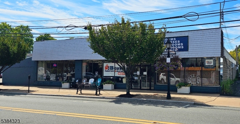 Property available for sale or lease. Prime Main Street location in Hackettstown featuring 0.878 acres on a high-visibility corner lot, with ingress/egress from three streets available and parking for approximately 45± vehicles, including 20 striped spaces and 4,400± sq. ft. of open parking with expansion potential. Zoned Town Center Commercial, the property includes a 14,600± sq. ft. building with showroom space including 10? ceilings, lean-to sections 7? to 9? ceilings, warehouse areas with 9? and 10? bay doors, and full public utilities. Zoning allows  three to four stories pending variance approval, making it ideal for mixed-use redevelopment. Walking distance to shops, dining, and other amenities. Seller open to short or long-term lease options.