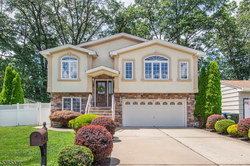 This beautifully updated 4 bed, 3 bath home offers a perfect blend of modern design and thoughtful upgrades. Step inside to an open-concept floor plan flooded with natural light, gleaming hardwood floors, and recessed lighting throughout. The kitchen is a chef's dream, boasting granite countertops, new stainless steel appliances, a center island and pantry perfect for entertaining and everyday living. Formal dining room, cozy eat-in kitchen nook and spacious family room featuring soaring vaulted ceilings all connect directly to the kitchen. Retreat to the primary suite, featuring a large walk-in closet with built-in organizers and a beautifully updated en-suite bath. Need more space? The lower level offers a  bedroom with a full bath perfect for guests, a den featuring  a custom wet bar great for entertaining, and a bonus room ideal for a home gym or office. Step through sliders to a paver patio and fully fenced, flat backyard complete with a built-in kitchenette and charcoal grill, professional landscaping, a full yard sprinkler system, and a shed for extra storage. Just minutes from the Parkway and close to vibrant downtown Cranford and Westfield, enjoy easy access to top-rated restaurants, shopping, and entertainment while coming home to your own peaceful retreat.