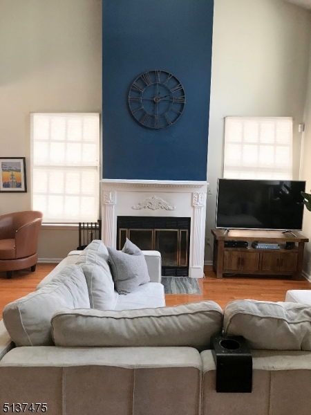 Beautiful 2 Bedroom, 2 1/2 Bath Multi-Floor End Unit Townhouse in Sought After Skyline Village. Modern and Updated, this Home Features High Volume and Cathedral Ceilings,Wood Floors Throughout and Plenty of Windows for a Bright and Warm Environment. The Open Floor Concept of Living Room, Dining Room, and Kitchen is great for Entertaining. The Spacious Eat-In Kitchen has Stainless Steal Appliances, Tile Backsplash, White Cabinets, and Features a Granite Breakfast Bar All Overlooking Oversized Windows and Sliders to Extended Deck. Dining Room also has Slider Doors Opening to Deck and Backyard. Bright Spacious Living Room Includes Wood Burning Fireplace. Large Master Bedroom Features Cathedral Ceiling, Multiple Closets, En Suite Bathroom with Wood Carpentry, and Sliders to a Second Deck for Enjoying Morning Coffee and Fantastic View. Spacious Second Bedroom is presently used as an Office. Lower Level has Family Room, Mud Room, Laundry Room, Storage and Inside Entrance to Garage. Central Vacuum, Alarm System. Amenities Include Community Pool and Clubhouse. Sale Includes Bedroom Mounted TV and Refrigerator in Garage. Conveniently Located Near Shopping, Major Highways, Mass Transit.